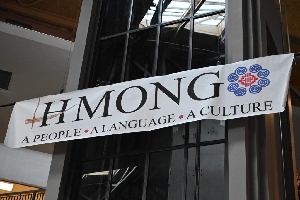 Close-up of a horizontal hanging banner that reads: HMONG - A People - A Language - A Culture.